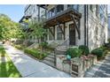 Row of townhouses with white brick exteriors, landscaping, and individual entrances at 18 Peachtree Ne Ave # 1, Atlanta, GA 30305