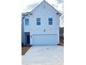 The exterior shows a modern home with white siding, a spacious garage, and a well-maintained concrete driveway at 1112 Edinberg Dr # 57, Villa Rica, GA 30180