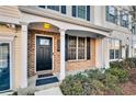 Townhome entrance with brick facade, black door, and porch at 273 Devonshire Dr, Alpharetta, GA 30022