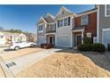 Townhome exterior, 2-car garage, and driveway parking at 520 Dragonfly Ct, Cumming, GA 30040