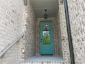 Close-up of the inviting glass-paneled front door with brick surround and charming light fixture at 1356 Lucan Ln # Wc226, Lawrenceville, GA 30043