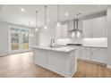 Bright kitchen featuring white cabinets, a center island, stainless steel appliances, and access to the deck at 344 Riverwood Pass, Dallas, GA 30157