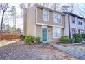 Tan two-story townhouse with green door and walkway at 6414 Wedgewood Trce, Tucker, GA 30084