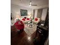 Living Room with hardwood floors, cream colored couch, and red accent chair at 200 Renaissance Ne Pkwy # 305, Atlanta, GA 30308