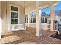 Charming front porch with brick flooring and a white swing at 5288 East Cherokee Dr, Canton, GA 30115