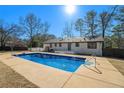 Inviting blue rectangular pool with concrete decking in backyard at 8951 Country Club Dr, Douglasville, GA 30134