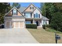 Brick and siding two-story house, three-car garage, and manicured lawn at 162 Gainesborough Dr, Dallas, GA 30157