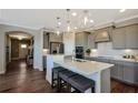 Modern kitchen with island, stainless steel appliances, and white quartz countertops at 2798 Turnwater St, Hoschton, GA 30548