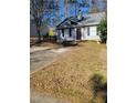 One story house with gray siding, burgundy front door and driveway at 906 Westland Sw Dr, Marietta, GA 30064