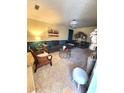 Spacious living room with gray sofa, wicker chairs, and a fireplace at 906 Westland Sw Dr, Marietta, GA 30064