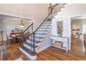 Two-story entry with hardwood floors and elegant staircase at 9970 Groomsbridge Rd, Johns Creek, GA 30022