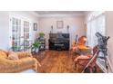 Bright home office featuring hardwood floors, piano, and seating at 9970 Groomsbridge Rd, Johns Creek, GA 30022