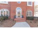 Elegant front entrance with arched door and brick detailing at 9970 Groomsbridge Rd, Johns Creek, GA 30022