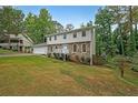 Two-story house with stone accents and a grassy yard at 1529 Bell Flower Ct, Stone Mountain, GA 30088