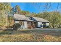 Gray house with stone accents and a large backyard at 1963 Tripp Rd, Woodstock, GA 30188