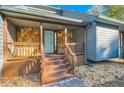 Inviting front porch with stone accents and wooden stairs at 1963 Tripp Rd, Woodstock, GA 30188