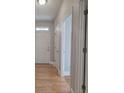 Light and bright hallway with hardwood floors and neutral walls at 2500 Rosehill Cir, Lithia Springs, GA 30122