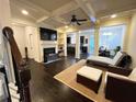 Open living room featuring coffered ceilings, fireplace, and abundant natural light at 3280 Hallmark Ln, Buford, GA 30519