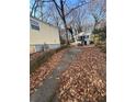 Side view of yellow house with a small yard and driveway at 1591 Woodland Se Ave, Atlanta, GA 30316