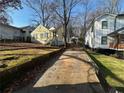 Yellow house with a small front yard and shared driveway at 1591 Woodland Se Ave, Atlanta, GA 30316