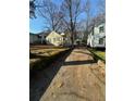 Yellow house on a tree-lined street with a shared driveway at 1591 Woodland Se Ave, Atlanta, GA 30316