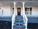 Inviting front entrance with a charming porch and steps leading to the front door at 1626 Saddlecreek Rd, Auburn, GA 30011