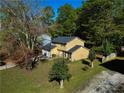 Two-story house on a wooded lot with a driveway at 2400 Reynolds Rd Sw, Atlanta, GA 30331