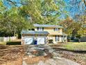 Two-story house with stone accents and a two-car garage at 2400 Reynolds Rd Sw, Atlanta, GA 30331