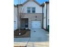 Brick front elevation of townhome with 2-car garage at 3313 Bell Nook Way, Lawrenceville, GA 30044