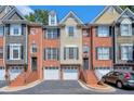 Three-story townhouses with attached garages and brick facade at 1506 Lavista Proper Cir, Decatur, GA 30033