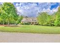 Beautiful house with a large green lawn and mature trees surrounding it at 8322 Saucier Dr, Douglasville, GA 30135