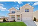 Charming two-story home with brick and siding, a well-manicured lawn, and an attached two-car garage at 2131 Landsburg Way, Lawrenceville, GA 30043