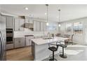 Modern kitchen boasts stainless steel appliances, a central island, and sleek gray cabinetry at 2131 Landsburg Way, Lawrenceville, GA 30043