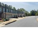 Exterior view of new townhomes boasting attached garages along a pristine street at 1346 Lucan Ln # Wc227, Lawrenceville, GA 30043