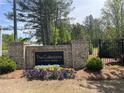 The Collections at Wolf Creek community sign is surrounded by seasonal flowers and landscaping at 1366 Lucan Ln # Wc225, Lawrenceville, GA 30043