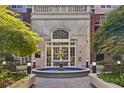 Building entrance with fountain and lush landscaping at 50 Biscayne Dr # 2109, Atlanta, GA 30309