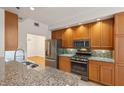 Updated kitchen with granite countertops, stainless steel appliances, and light wood cabinetry at 50 Biscayne Dr # 2109, Atlanta, GA 30309