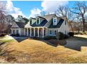 Gray sided two story house with a large front yard at 4248 Hog Mountain Rd, Hoschton, GA 30548