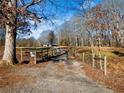 Long private driveway leading to a charming home with mature trees at 4258 Hog Mountain Rd, Hoschton, GA 30548