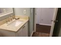 Small bathroom with a vanity, sink, and updated flooring at 33 Country Place Ct, Alpharetta, GA 30005