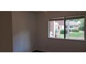 Bright bedroom with a window and dark brown flooring at 33 Country Place Ct, Alpharetta, GA 30005