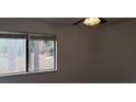 Simple bedroom with large window and ceiling fan at 33 Country Place Ct, Alpharetta, GA 30005