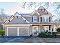 Two-story house with gray siding, two-car garage, and landscaped yard at 4905 Clearstone Nw Way, Acworth, GA 30101