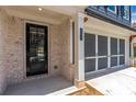 Front entry of townhome with brick facade and black front door at 202 Grady Burrell Dr, Holly Springs, GA 30115