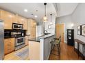 Modern kitchen with stainless steel appliances and light wood cabinets at 943 Peachtree Ne St # 809, Atlanta, GA 30309