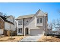 Two-story house with light brick exterior, gray roof, and a paved driveway at 292 Creighton Ave, Scottdale, GA 30079