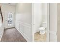 Bright foyer with tile floors, half bathroom, and wainscoting at 6057 Hemperly Rd, Atlanta, GA 30349