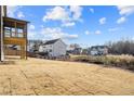 Spacious backyard with a deck and screened porch, overlooking neighboring homes at 23 Rockberry Ct, Dallas, GA 30157