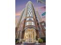 Stunning exterior view of the high-rise building with brick facade and glass entryway at 325 E Paces Ferry Rd # 1110, Atlanta, GA 30305