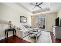 Spacious living room with hardwood floors, sectional sofa, and balcony access at 325 E Paces Ferry Rd # 1110, Atlanta, GA 30305